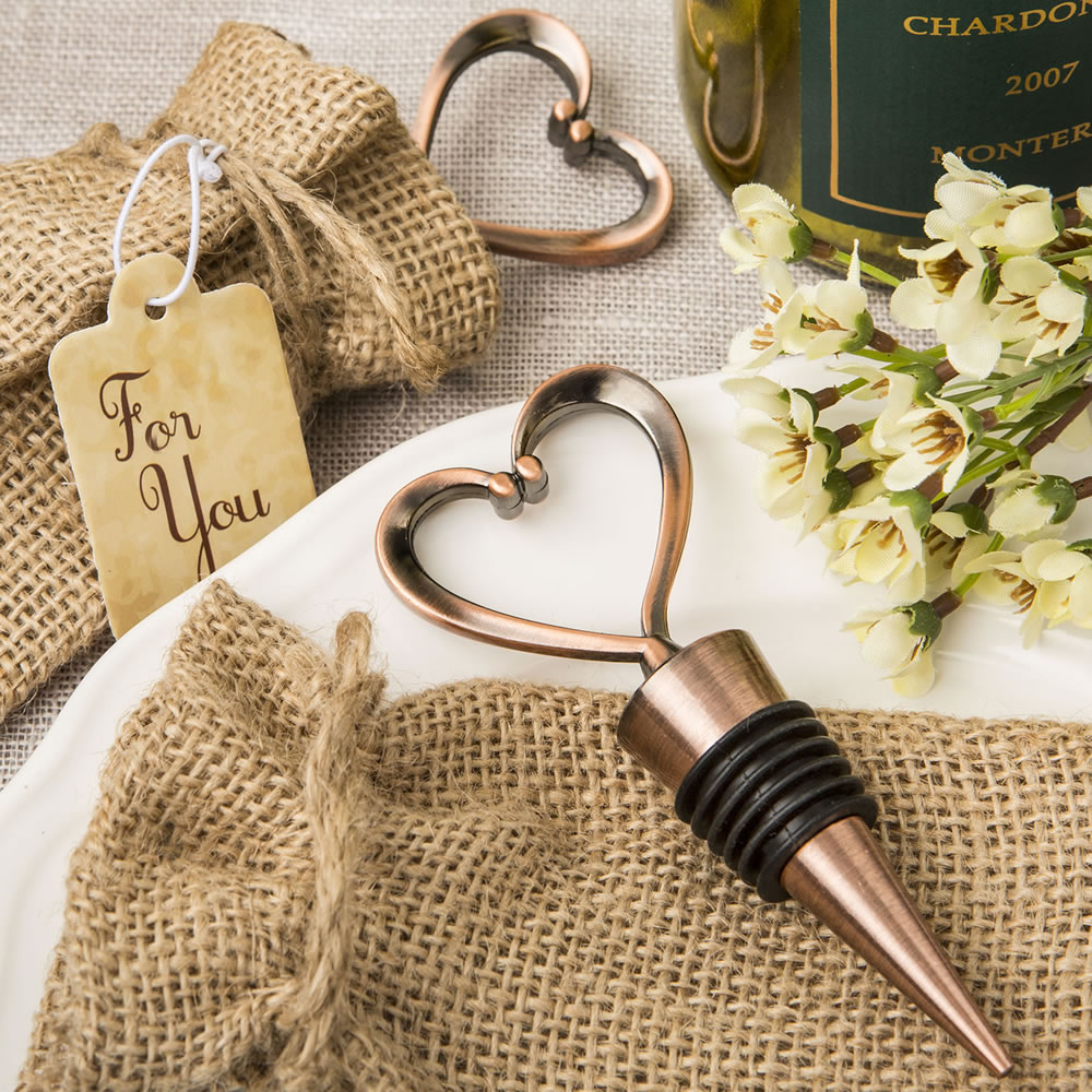 Heart shaped metal bottle stopper in a Copper plated finish in a burlap bag
